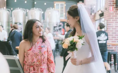 Ellie laughing with a bride on her Gold Coast wedding day