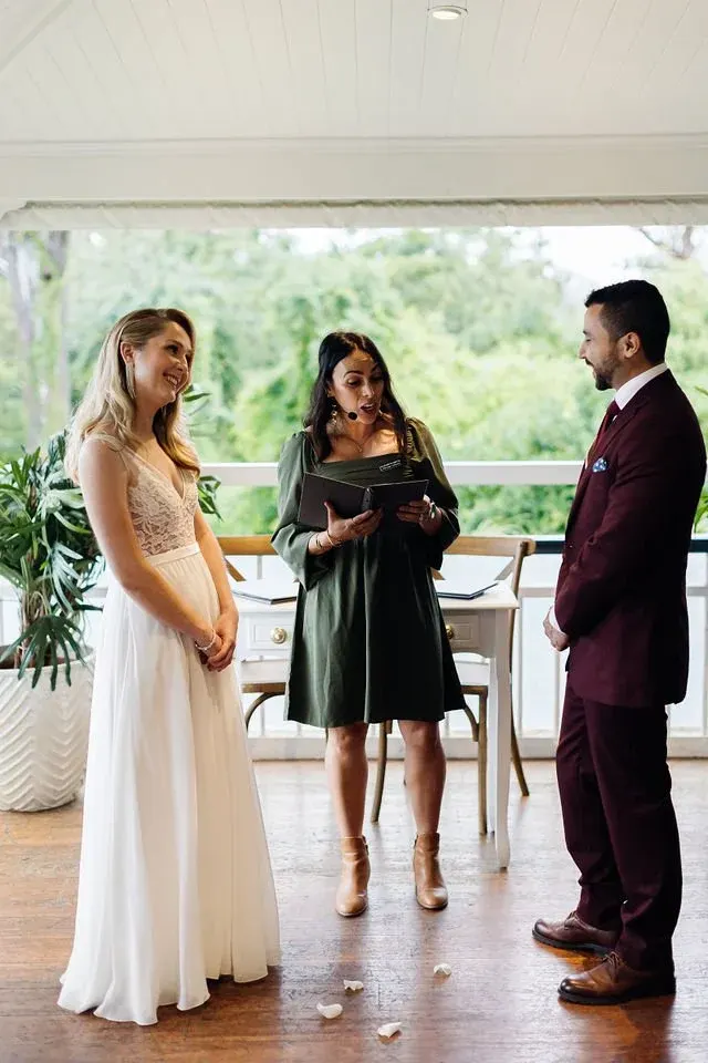 Wedding ceremony: Ellie officiating an intimate indoor celebration